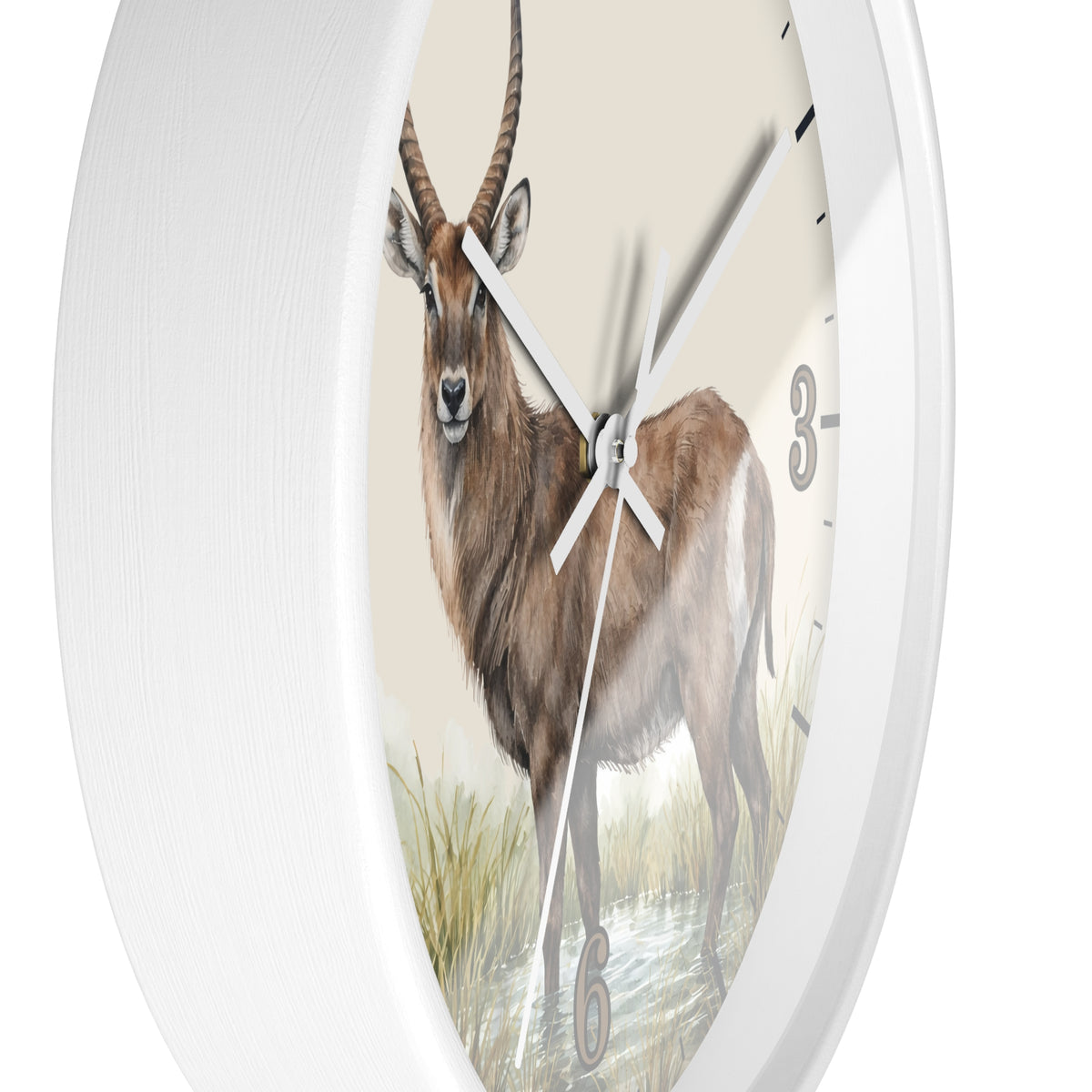 A white oval wall clock featuring a detailed illustration of a brown antelope or gazelle on the clock face, with white hands and black numerals.