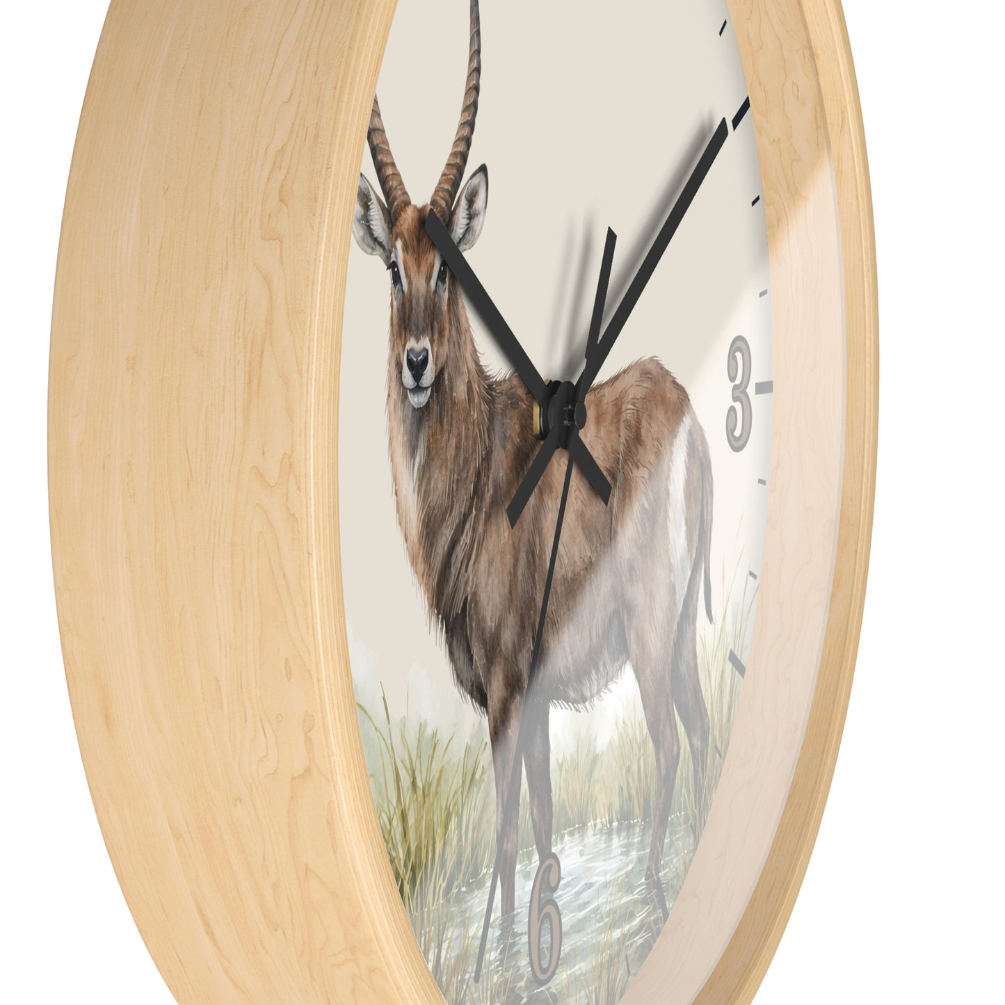 Round wall clock with a light natural wood frame and a printed animal face in the center, showing a brown antelope/gazelle with horns against a pale background. Black clock hands and sparse black numerals are visible.