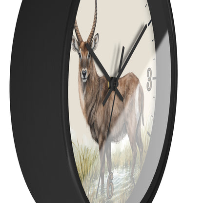 A round wall clock with a black frame and a printed natural history-style illustration of a brown antelope on the face, with black hands and small gray numerals.