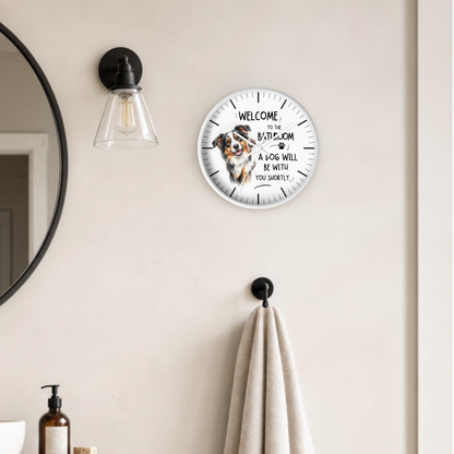 round white framed wood wall clock with an Australian shepherd illustration and text " Welcome to the Bathroom A Dog Will Be With You Shortly"