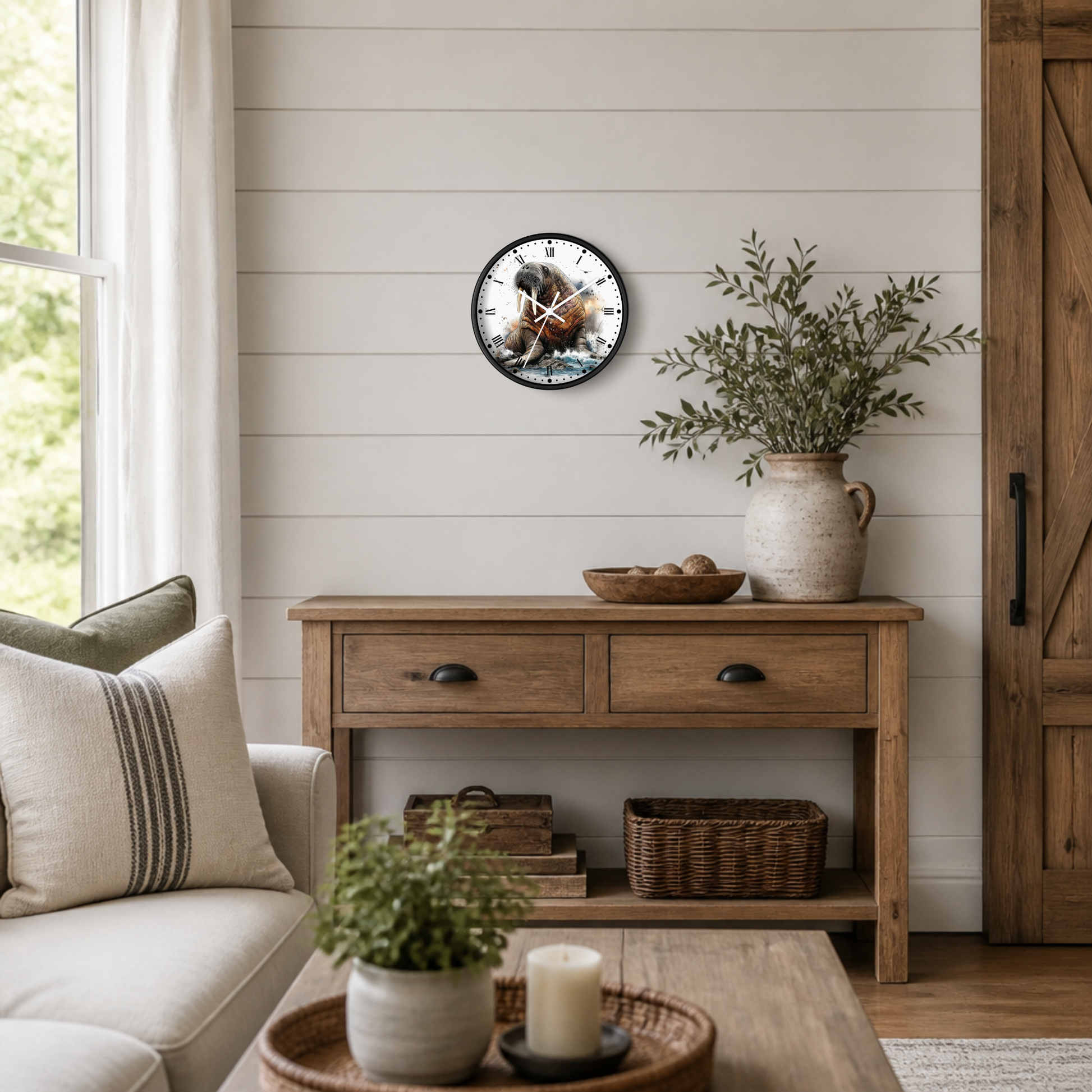 A round wall clock featuring a detailed illustration of an walrus in the ocean, styled on a white shiplap wall above a rustic wooden console table in a cozy living room setting.