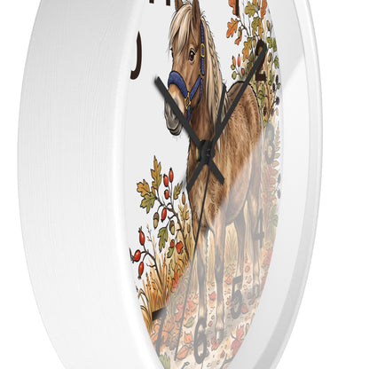 Round white wall clock featuring an illustration of a brown horse with a blue halter and autumn foliage on the face.