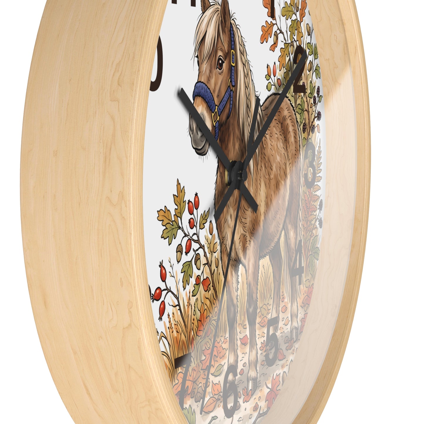 Round wall clock with a light natural wood frame and a printed horse illustration on the face, featuring a brown horse with a blue halter and autumn foliage.