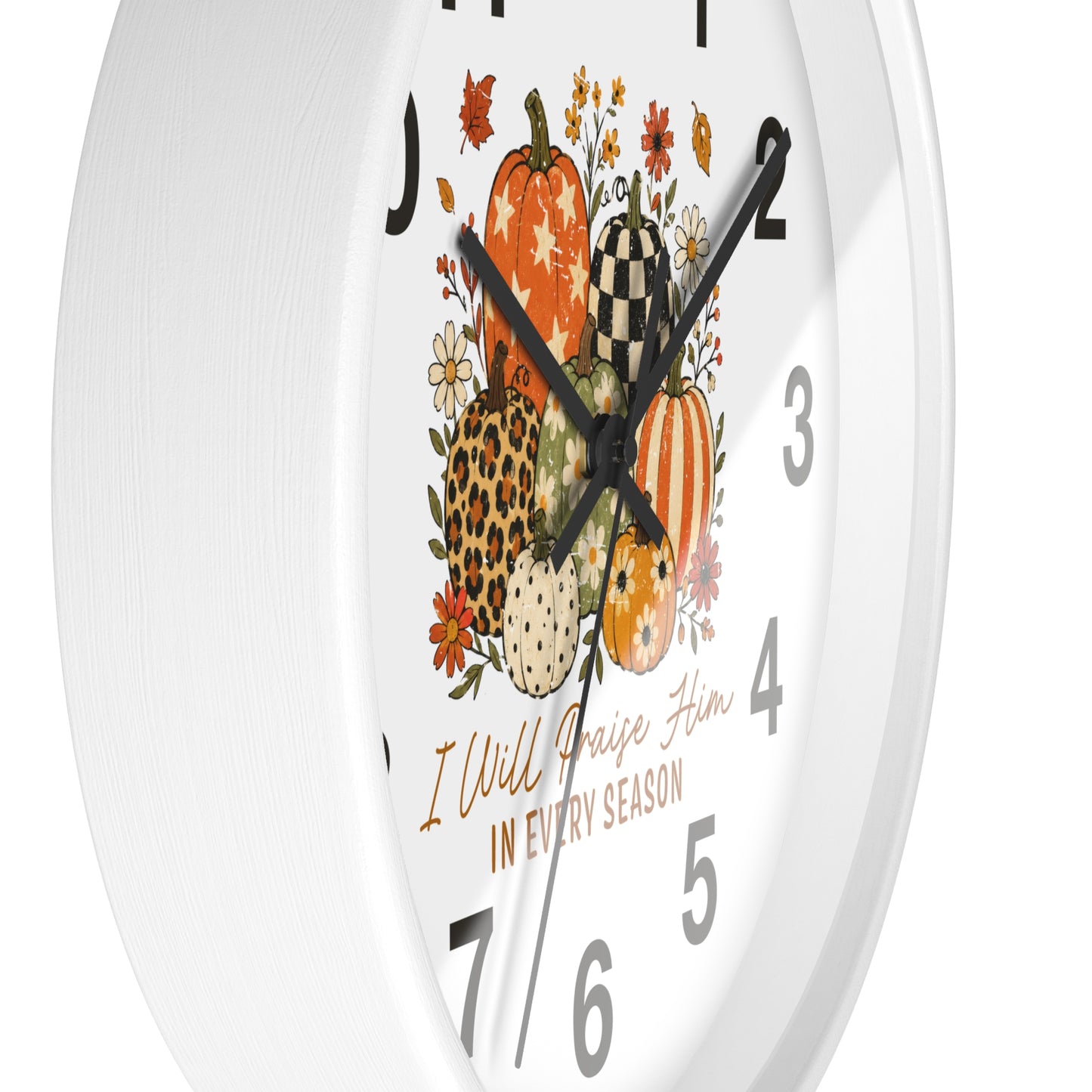 White round wall clock with a fall harvest design featuring illustrated pumpkins, flowers, and the text 'I Will Raise Him IN EVERY SEASON'.