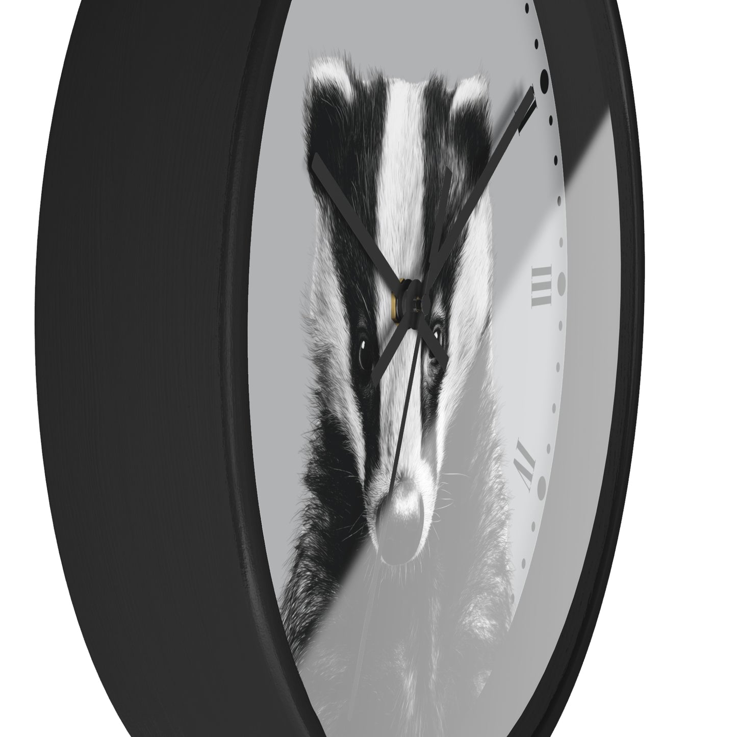 A round wall clock with a black frame and a grayscale print of a badger face on the clock face, shown against a plain white background.