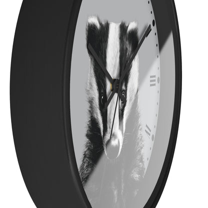 A round wall clock with a black frame and a grayscale print of a badger face on the clock face, shown against a plain white background.