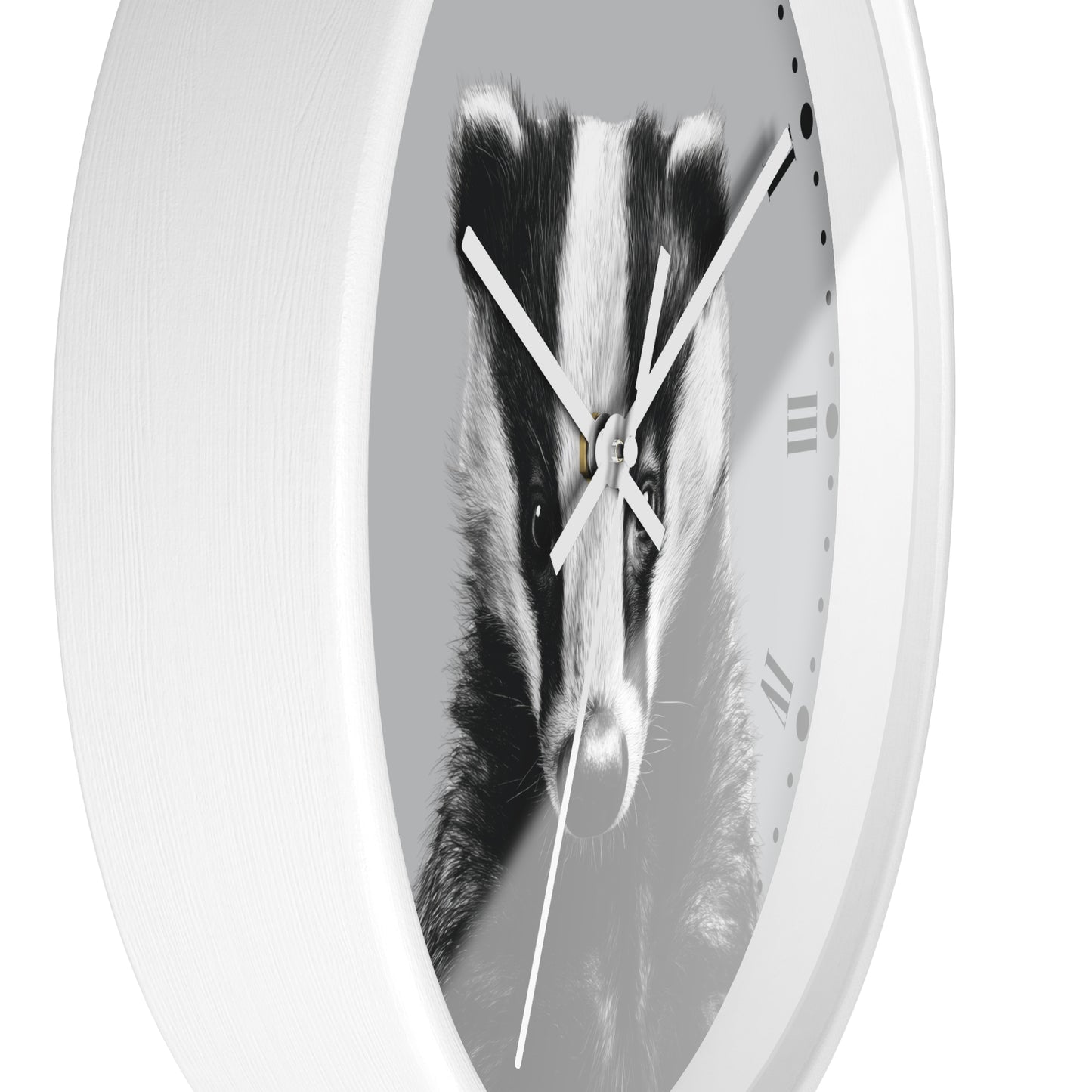 A white oval wall clock featuring a black and white photograph of a badger on the clock face, with white hands and minimal Roman numerals.