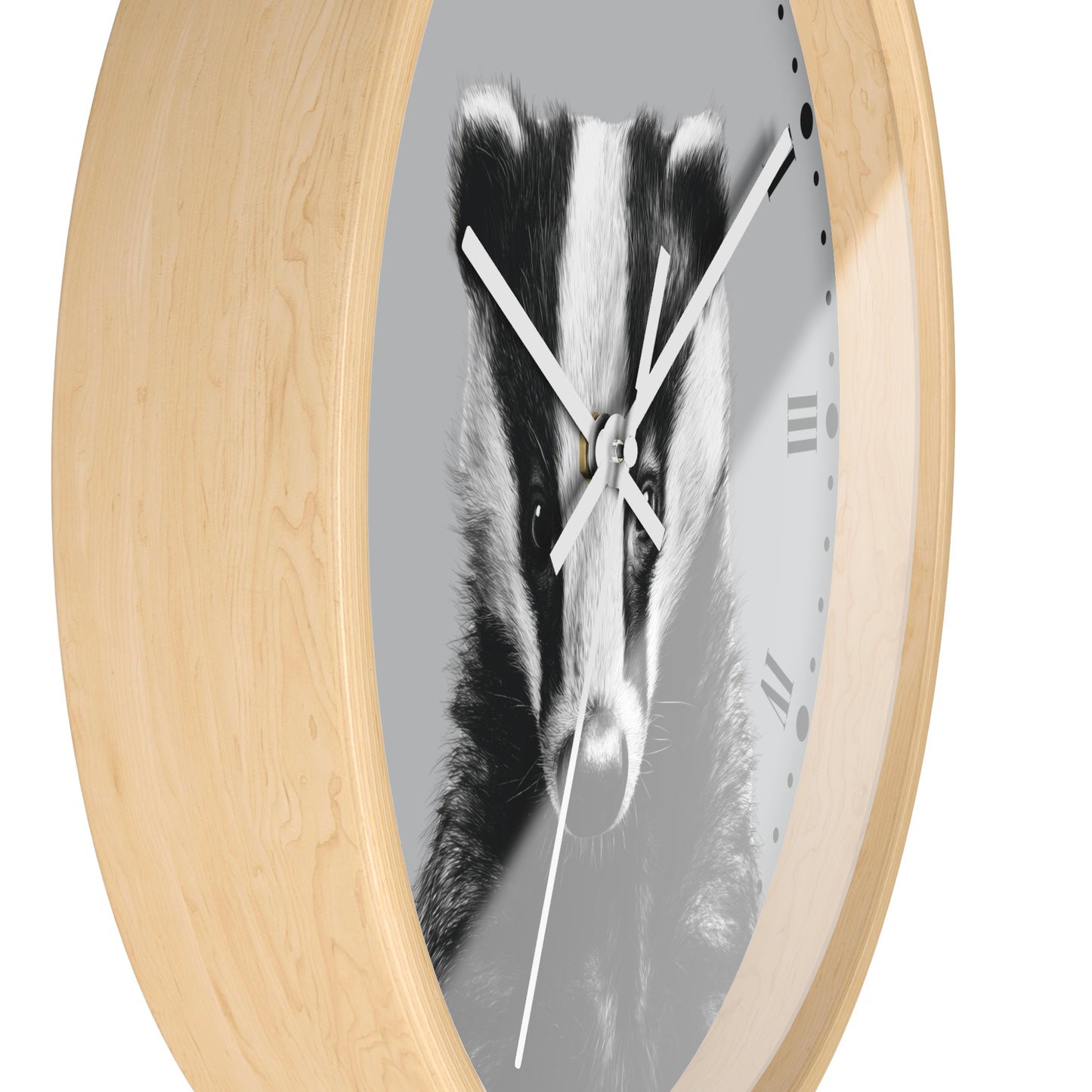Round wall clock with a light natural wood frame and a grayscale print of a badger face on the dial, with white hands and black Roman numerals.