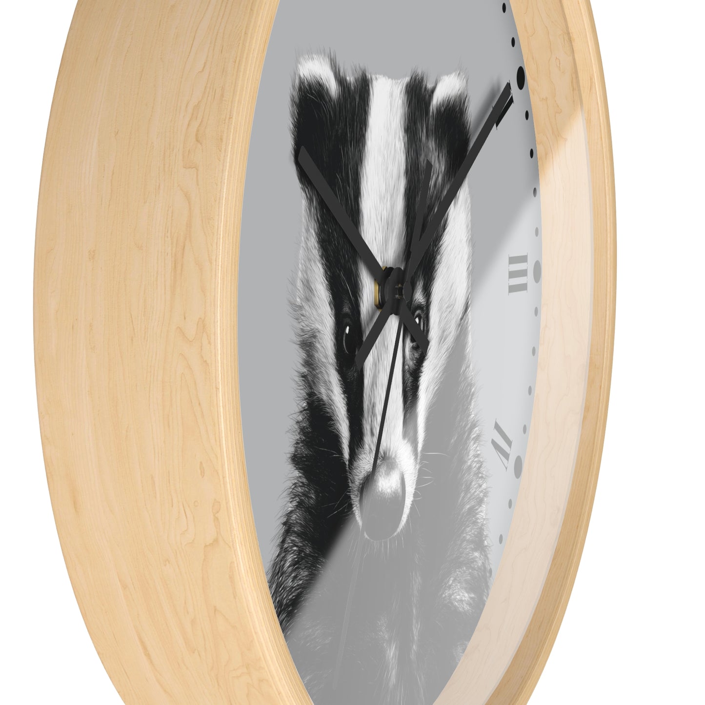 Round wall clock with a light natural wood frame and a grayscale print of a badger face on the dial, shown against a plain white background.