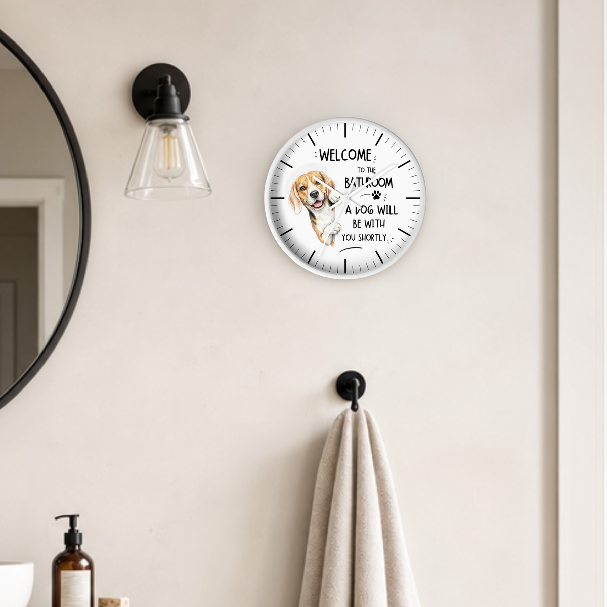 A round wall clock with a white face, beagle dog illustration and black text reading 'WELCOME TO THE BATHROOM A DOG WILL BE WITH YOU SHORTLY.