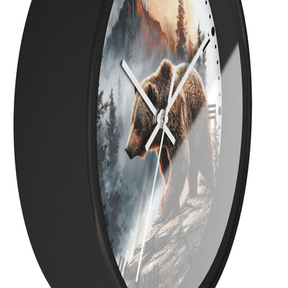 Round wall clock with a black frame and a printed design of a brown bear walking through a misty forest at sunrise, shown against a plain white background.