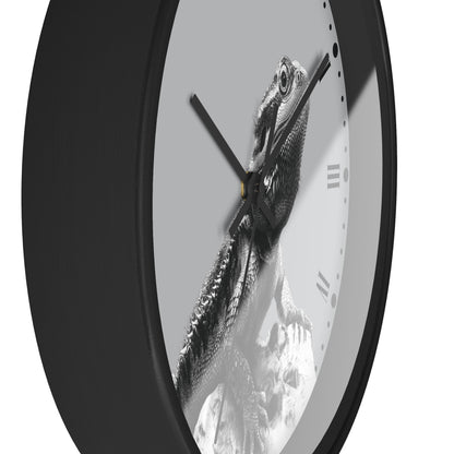 A close-up of a round wall clock with a black frame and a monochrome bearded dragon printed on the clock face, shown against a white background.