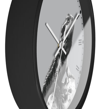 A close-up of a round wall clock with a black frame and a monochrome photographic print of a bearded dragon lizard on the clock face, with white hands and Roman numeral hour markers.