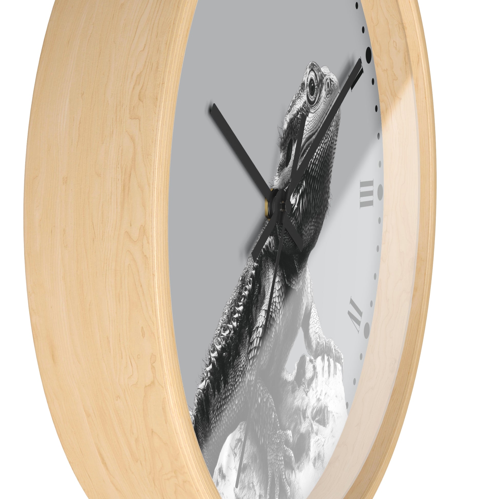 Round wall clock with a light natural wood frame and a black-and-white photographic print of a bearded dragon lizard on the clock face, shown against a plain white background.