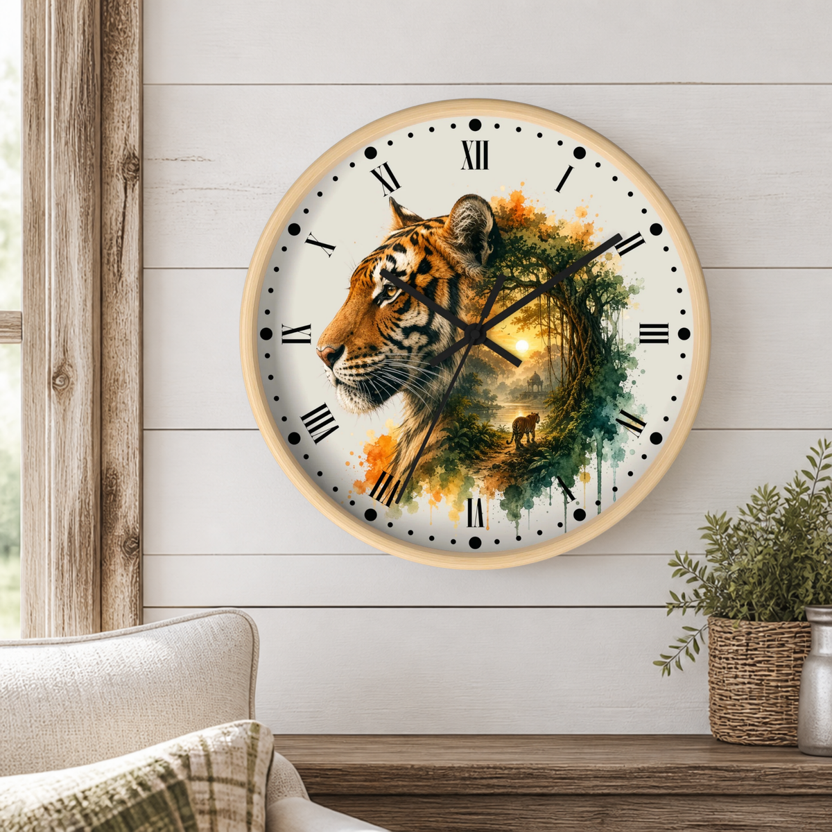 A round wall clock with a light wood frame and a white face, featuring a detailed illustration of a tiger's face blended with a forest scene and a small deer. The clock is mounted on a white shiplap wall above a wooden table with a potted plant and a sofa visible.