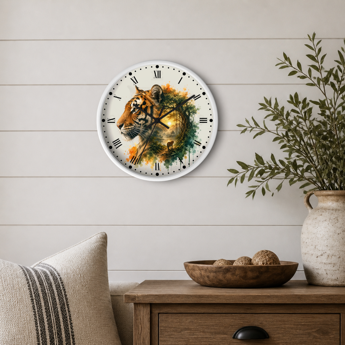 A round wall clock with a white frame and a watercolor-style tiger illustration on the face, mounted on a light beige shiplap wall above a wooden side table with a vase and bowl.