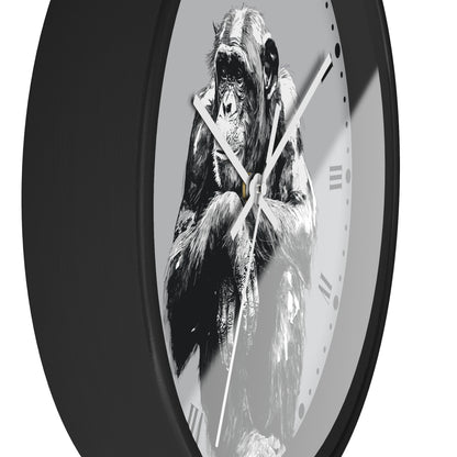 A round wall clock with a black frame and a monochrome illustration of a chimpanzee on the face, set against a plain white background.