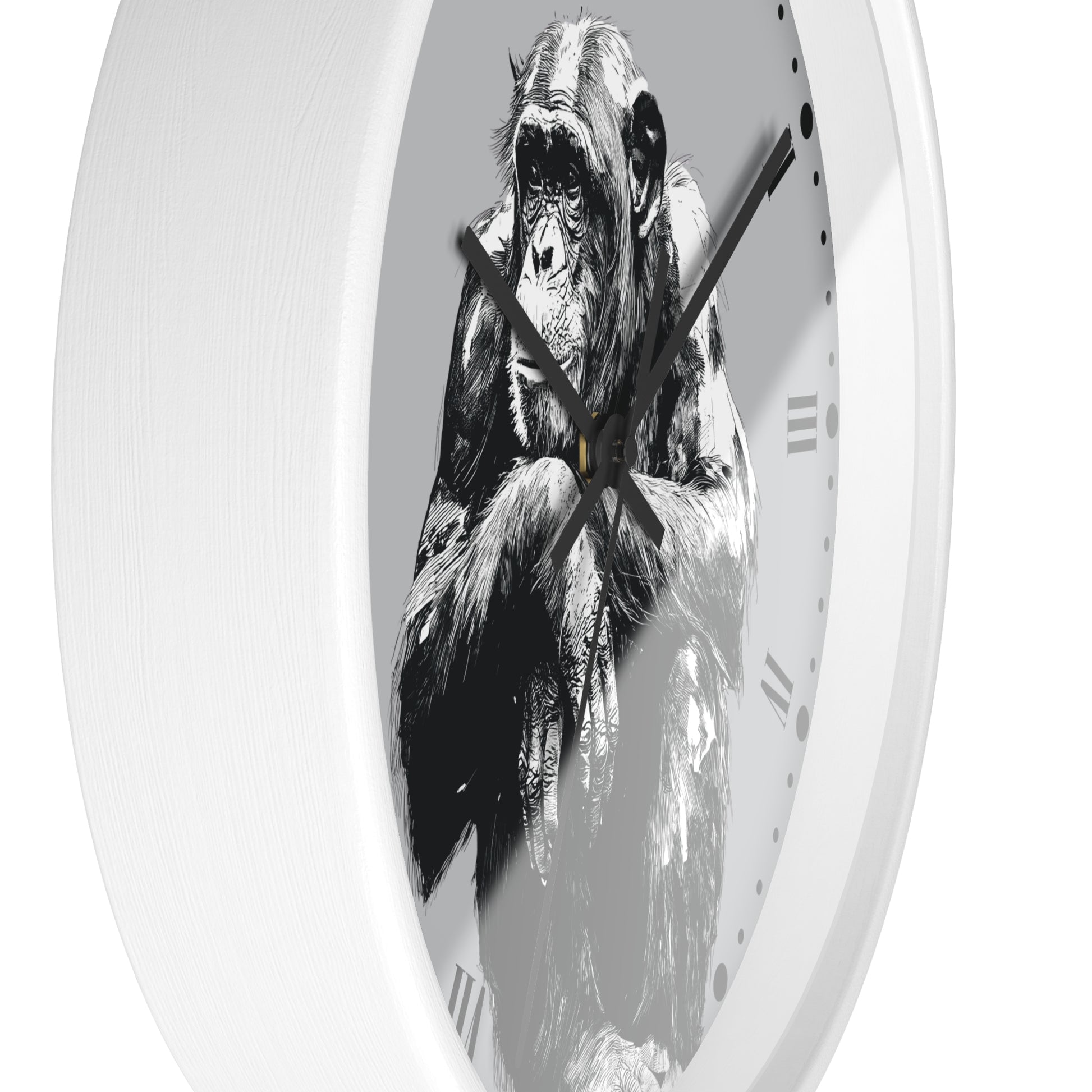 A white round wall clock featuring a black and white illustration of a chimpanzee on the face of the clock, with black hands and Roman numeral hour markers.