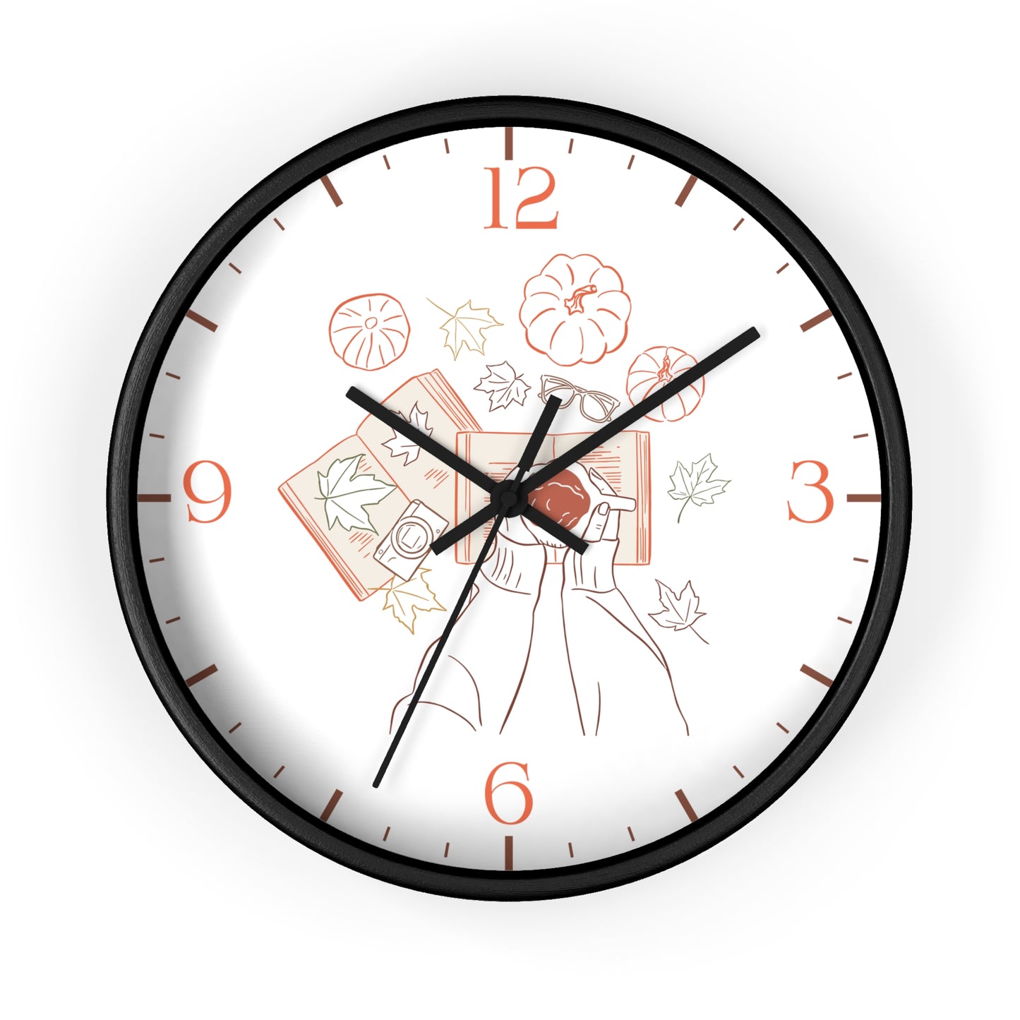 A round wall clock with a black frame and a white face featuring a minimalist line art illustration of a woman holding books and pumpkins, with orange numerals and black hands.
