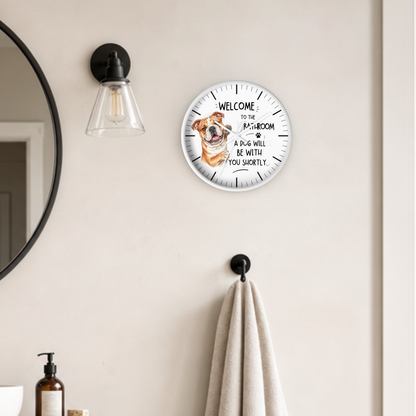 A round wall clock with a white face and black text reading 'WELCOME TO YOUR BOTTLEJAM A DOG WILL BE WITH YOU LATER.