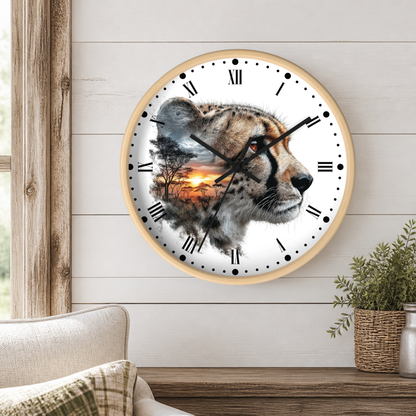 A round wall clock with a light wood frame hangs on a white shiplap wall above a wooden table. The clock face features a photographic cheetah head with a sunset landscape double-exposed print.