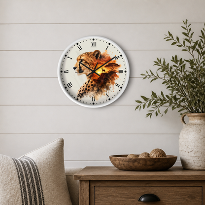 A round wall clock with a watercolor-style cheetah illustration, mounted on a light beige shiplap wall above a wooden side table with a vase and bowl.
