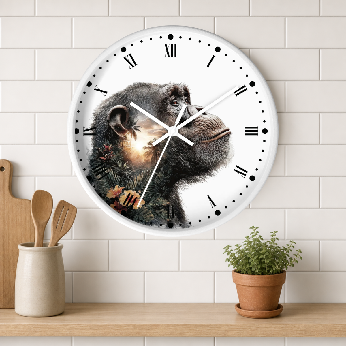 A round wall clock with a chimpanzee illustration on the face, mounted on a white subway-tile wall above a wooden shelf with kitchen utensils and a potted plant.