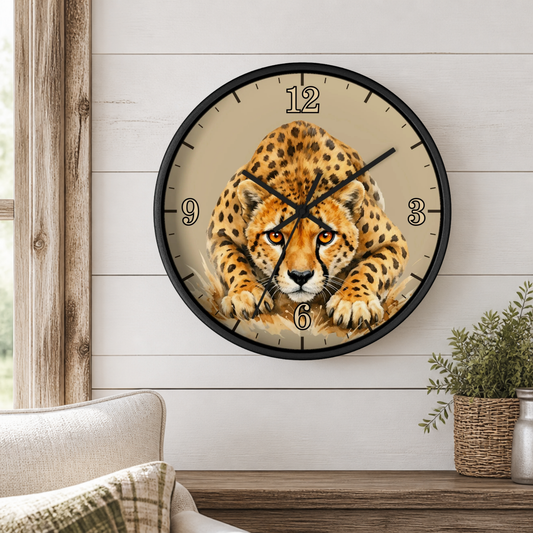 A round wall clock with a black frame and a cheetah print face, mounted on a white shiplap wall above a wooden console table with a small potted plant.