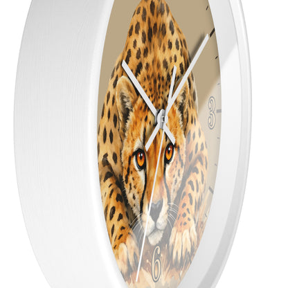 Round wall clock with a white frame and a printed cheetah face in the center, with white clock hands and partial black numerals visible.