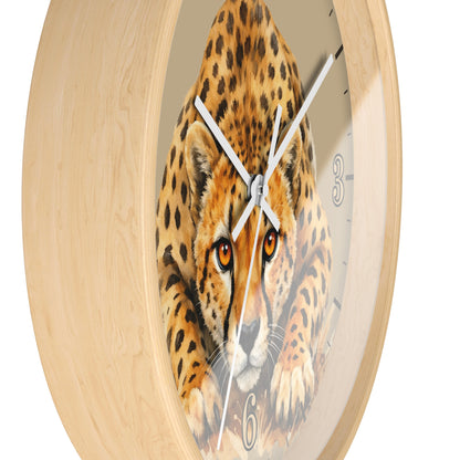 A round wall clock with a light natural wood frame and a printed cheetah face on the dial, with white hands and black hour markers, shown against a plain white background.