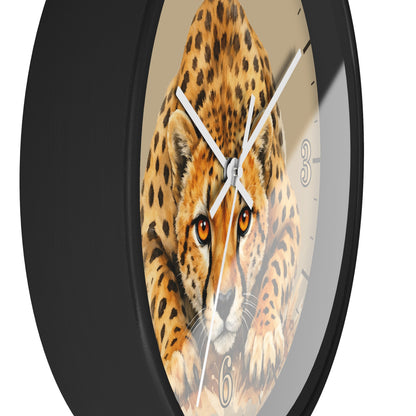 A round wall clock with a black frame and a printed cheetah face on the dial, with white hands and partial black Arabic numerals visible against a plain white background.