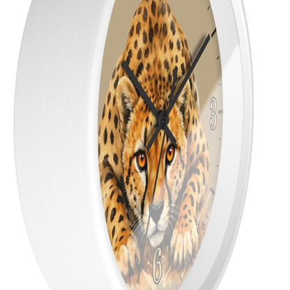 Round wall clock with a white frame and a printed cheetah face in the center, with black hands and partial black numerals visible on a light beige dial.