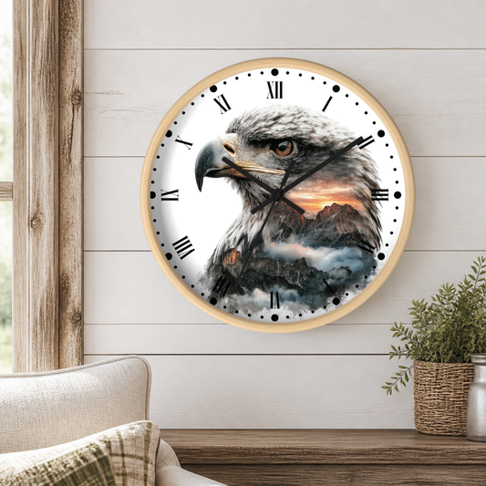 Round wall clock with a light wood frame featuring a detailed eagle and mountain landscape print, mounted on a white shiplap wall above a wooden console table with a plant and part of a sofa visible.