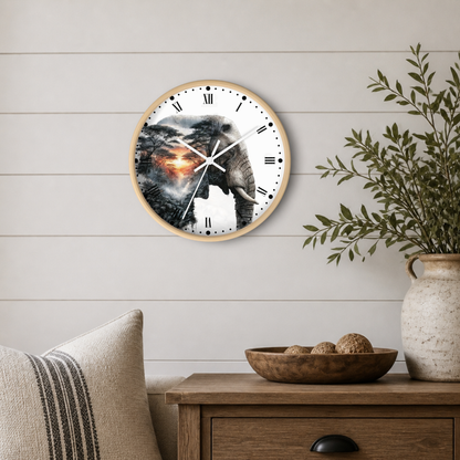 Round wall clock with a light wood frame and an elephant artwork printed on the face, hanging on a white shiplap wall above a wooden side table with a vase and bowl.