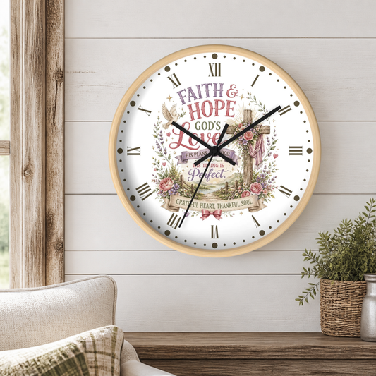 A round wall clock with a light wood frame hangs on a white shiplap wall above a wooden table. The clock face features a Christian-themed graphic with the words 'FAITH & HOPE GOD'S Love' and 'PERFECT' surrounded by floral and cross illustrations.
