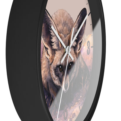 A round wall clock with a black frame and a printed illustration of a fox face on the clock face, with white hands and gray numerals, shown against a plain white background.