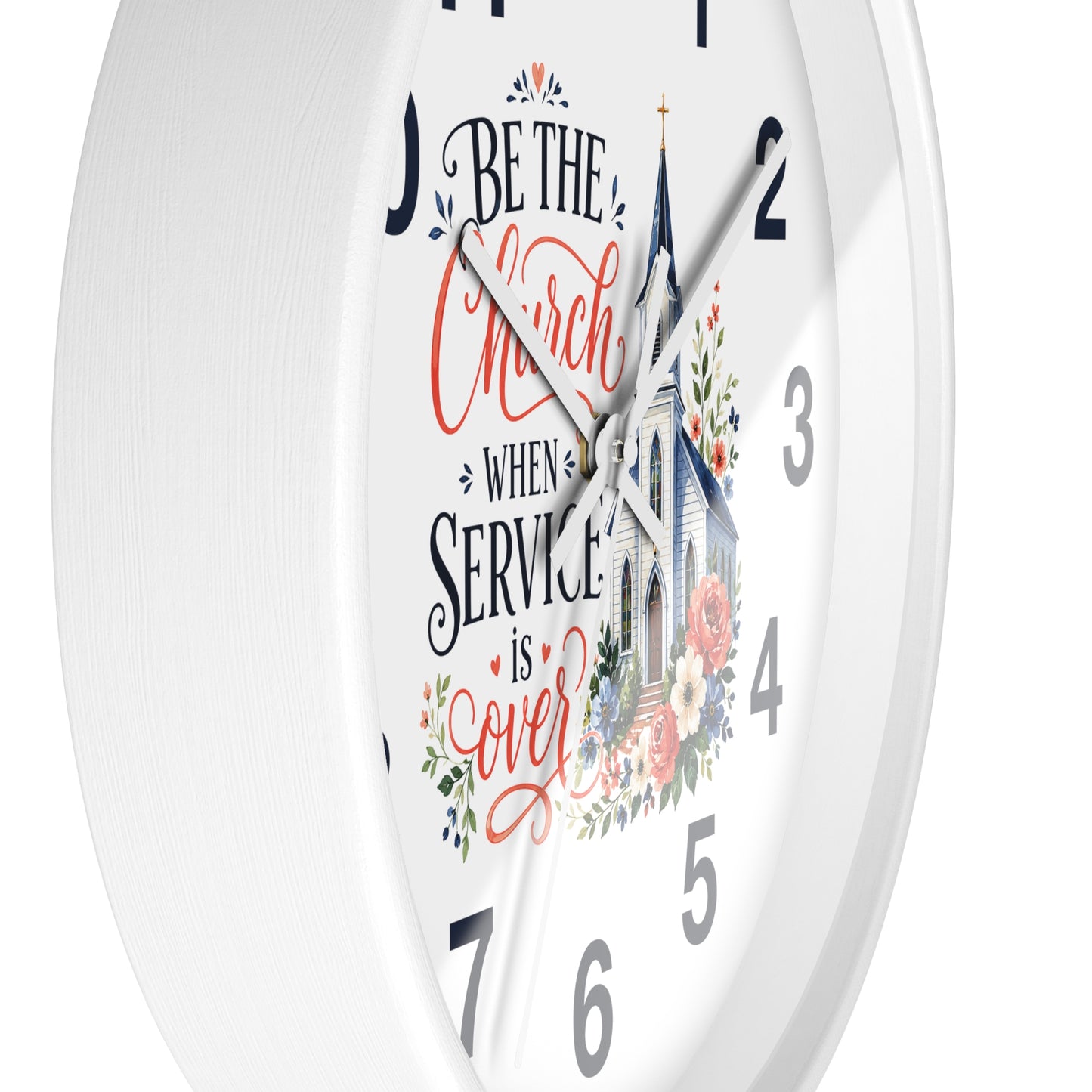 A white round wall clock with a printed church illustration and the phrase “Be the Church When Service is Over” in black and coral script, shown against a white background.