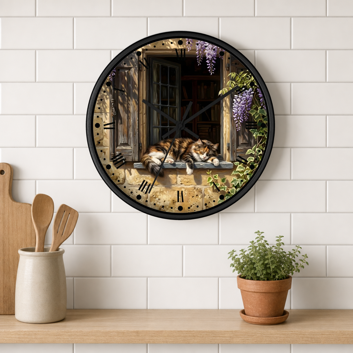 A round wall clock with a black frame hangs on a white subway tile wall above a wooden shelf. The clock face features an artistic print of a cat sleeping on a windowsill with purple wisteria flowers and a rustic stone wall background.