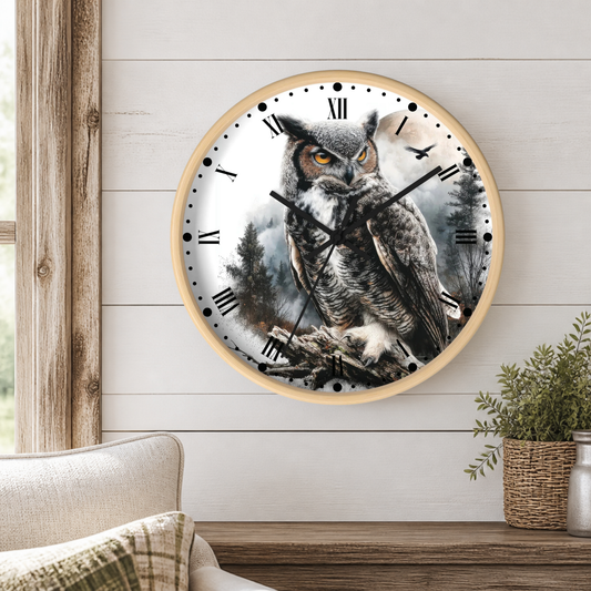 A round wall clock with a light wood frame and a printed owl illustration on the face, mounted on a white shiplap wall above a wooden console table with a plant and part of a sofa visible.
