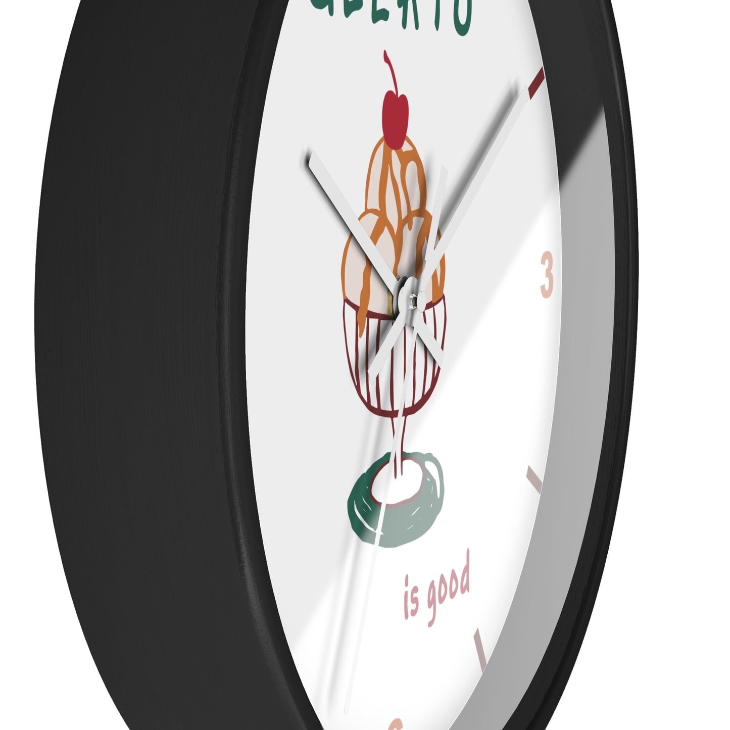 A close-up of a round wall clock with a black frame and a white face featuring a colorful ice cream sundae illustration and the words 'GELATO is good'.