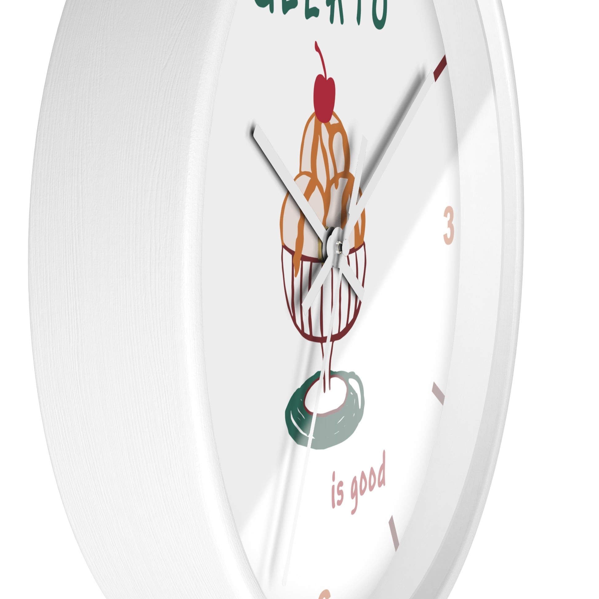 A white round wall clock with a minimalist ice cream scoop illustration in the center and the phrase 'is good' printed near the bottom.