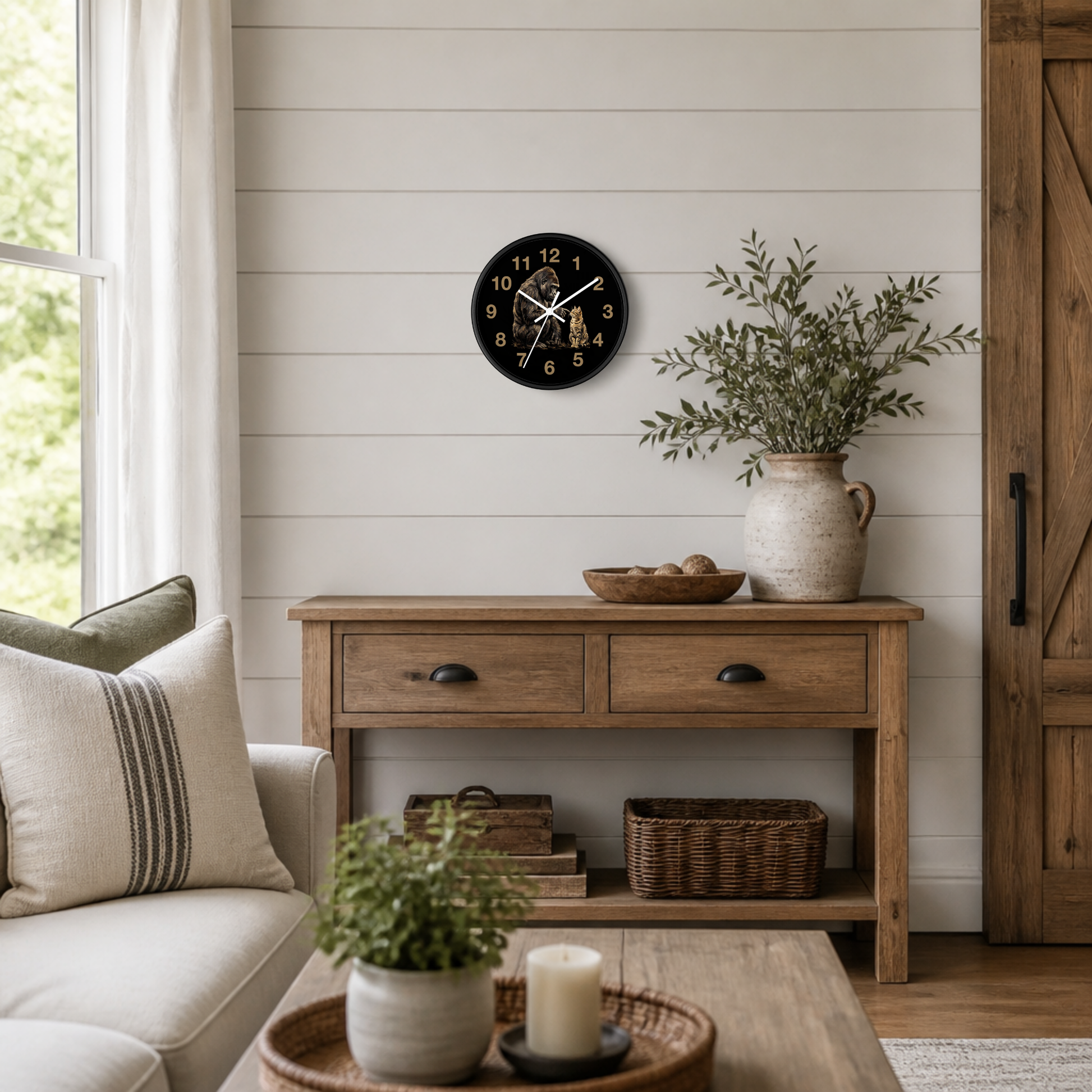 A round black wall clock with gold numerals and hands hangs on a white shiplap wall above a rustic wooden console table in a bright, modern farmhouse-style living room.