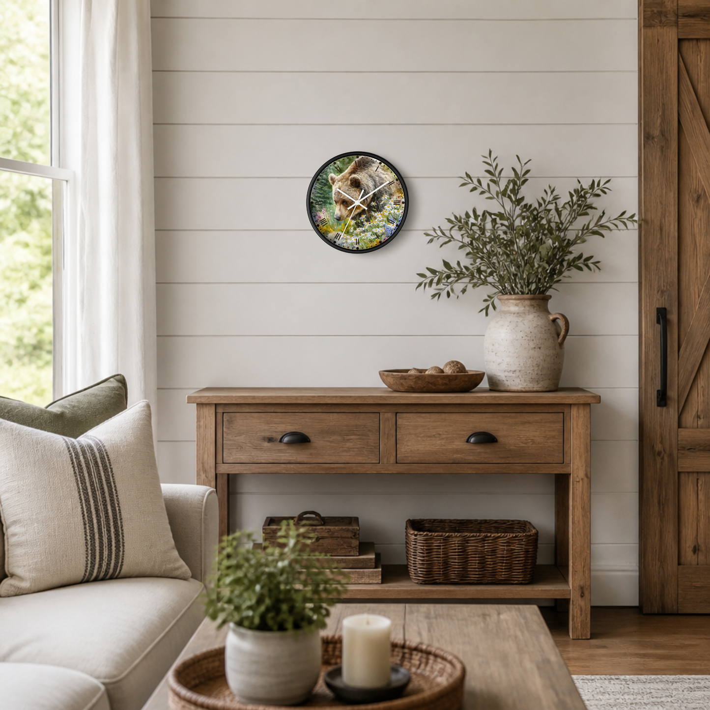 A round wall clock featuring a rustic horse illustration hangs on a white shiplap wall above a wooden console table in a styled living room setting.