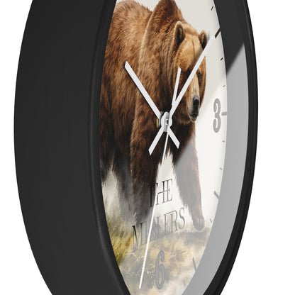 A round wall clock with a black frame and a white dial featuring a large brown bear illustration and the text 'THE NINERS'.