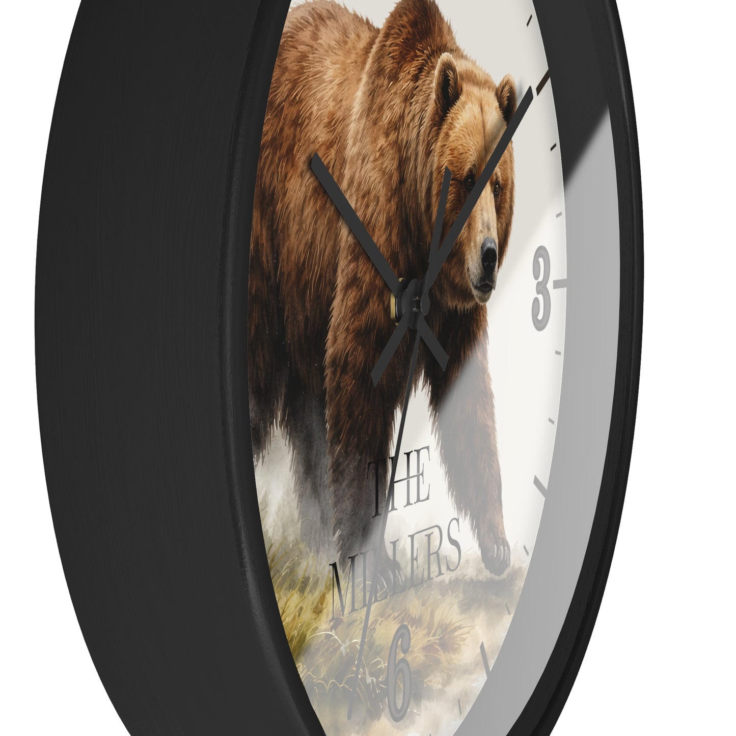 A round wall clock with a black frame and a printed face showing a brown grizzly bear walking over rocks, with black hands and partial numerals on a white background.