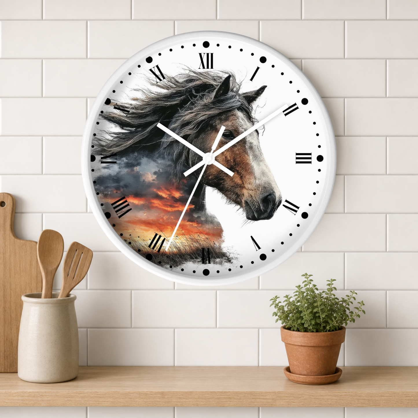 A round wall clock with a white frame and a printed horse portrait over a dramatic sunset scene. The clock is mounted on a white subway-tile wall above a wooden shelf with a small potted plant and wooden utensils.