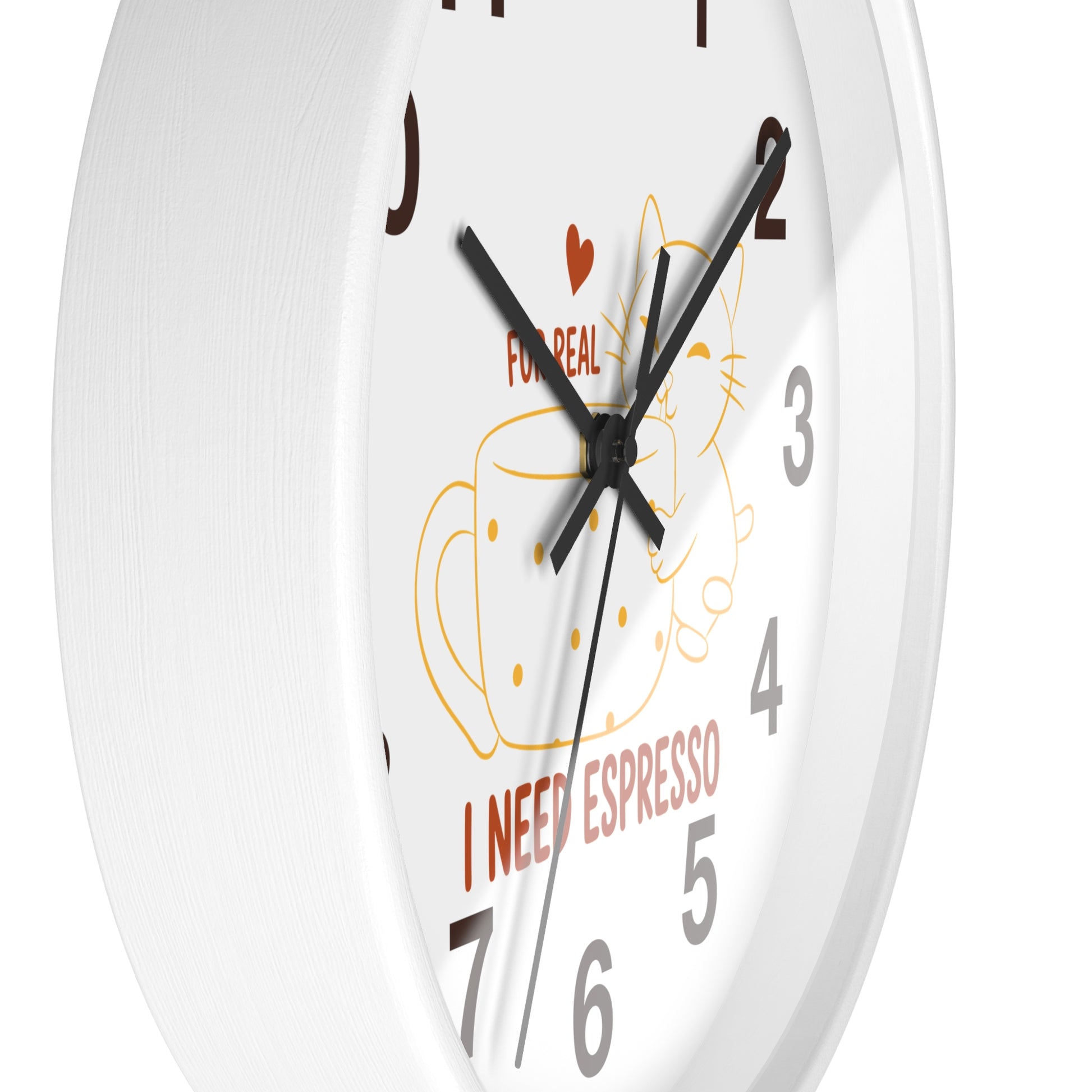 A close-up of a white wall clock with black hands, gray numerals, and a coffee-themed illustration featuring a cup, cat outline, red heart, and the text 'FOR REAL I NEED ESPRESSO'.