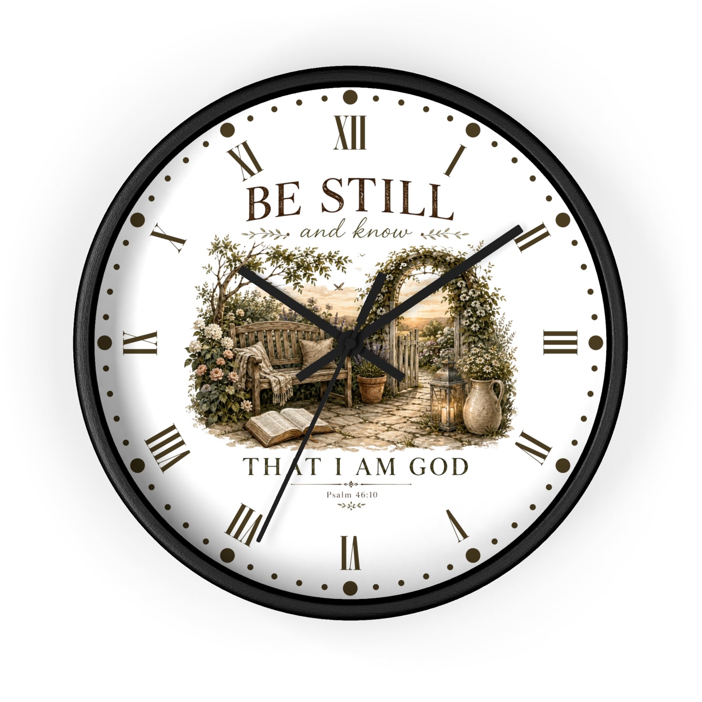 A round wall clock with a black frame and a white face featuring a vintage-style illustration of a garden scene with an open book and the text 'BE STILL and know THAT I AM GOD' with scripture reference Philippians 4:13.