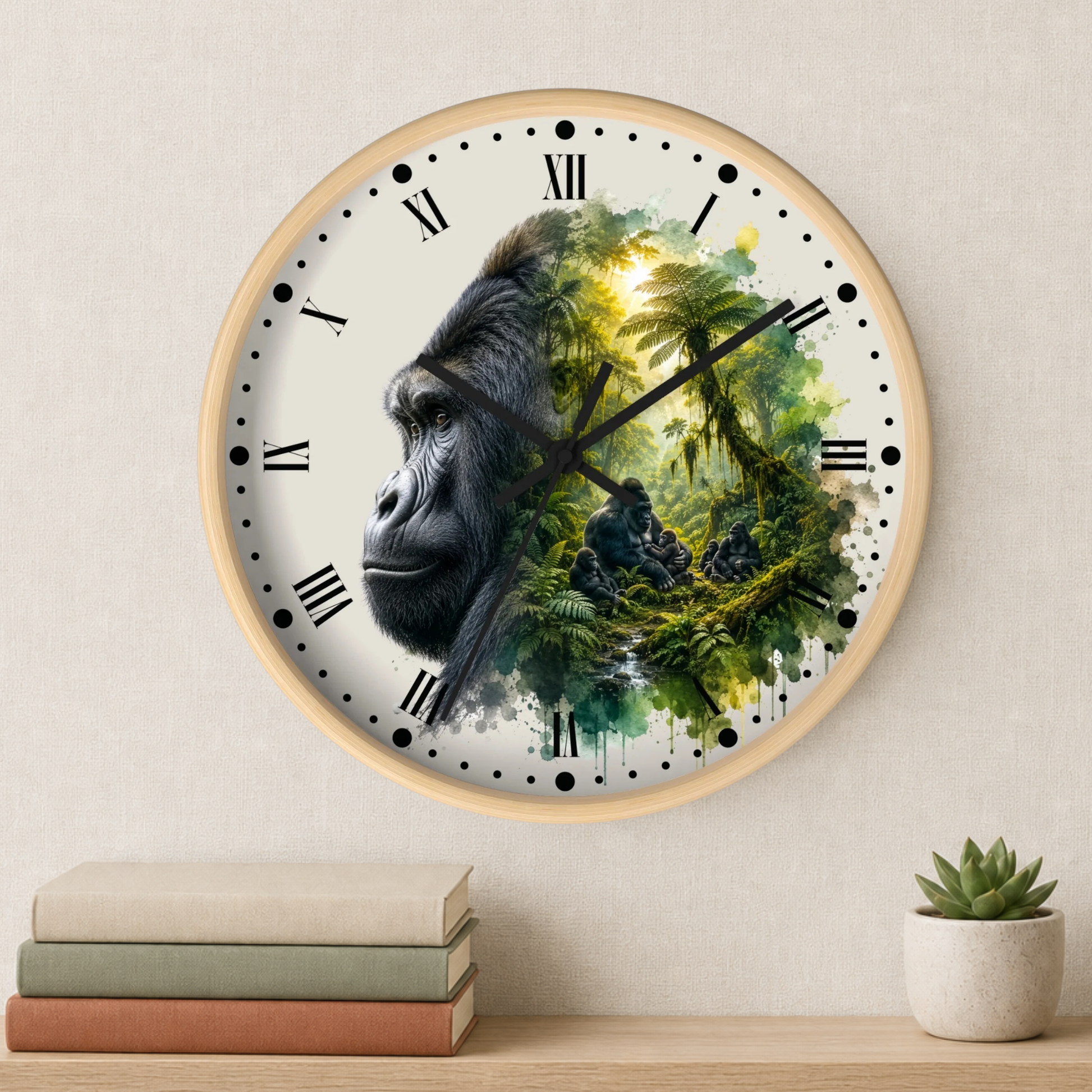 A round wall clock with a light wood frame and black Roman numerals, featuring a gorilla portrait blending into a lush green jungle scene. The clock is mounted on a beige wall above a shelf with stacked books and a small potted succulent.