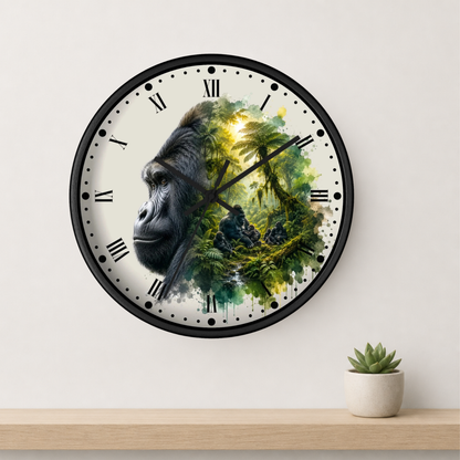 A round wall clock with a black frame and Roman numerals, featuring a split design of a gorilla's face on the left and a lush green jungle scene on the right. The clock is mounted on a light beige wall above a wooden shelf with a small potted succulent.